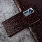 Close-up of crocodile embossed leather texture on luxury iPhone case - Dark Brown color for iPhone 17 Pro