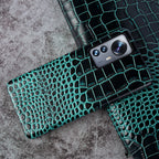 Close-up of crocodile embossed leather texture on luxury iPhone case - Dark Green color for iPhone 17 